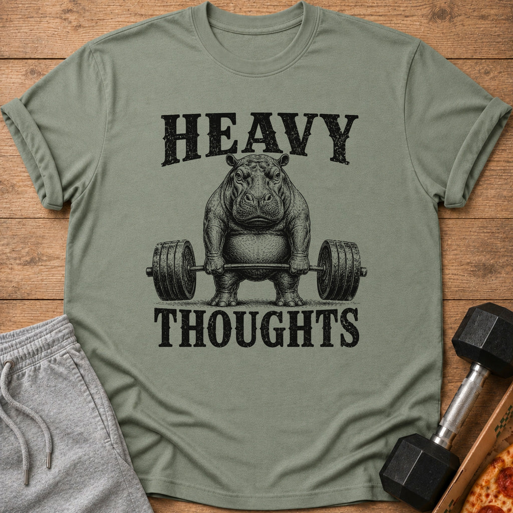 Green t-shirt with black text "HEAVY THOUGHTS" above a hippo lifting weights.