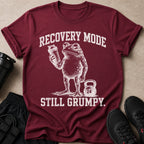 Maroon t-shirt with distressed print of a grumpy frog holding a shaker bottle and a kettlebell.