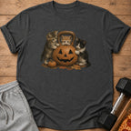 Three kittens interact with a jack-o'-lantern shaped kettlebell and a small pumpkin.