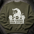 Olive green sweatshirt with a white graphic of a struggling opossum lifting weights and text.