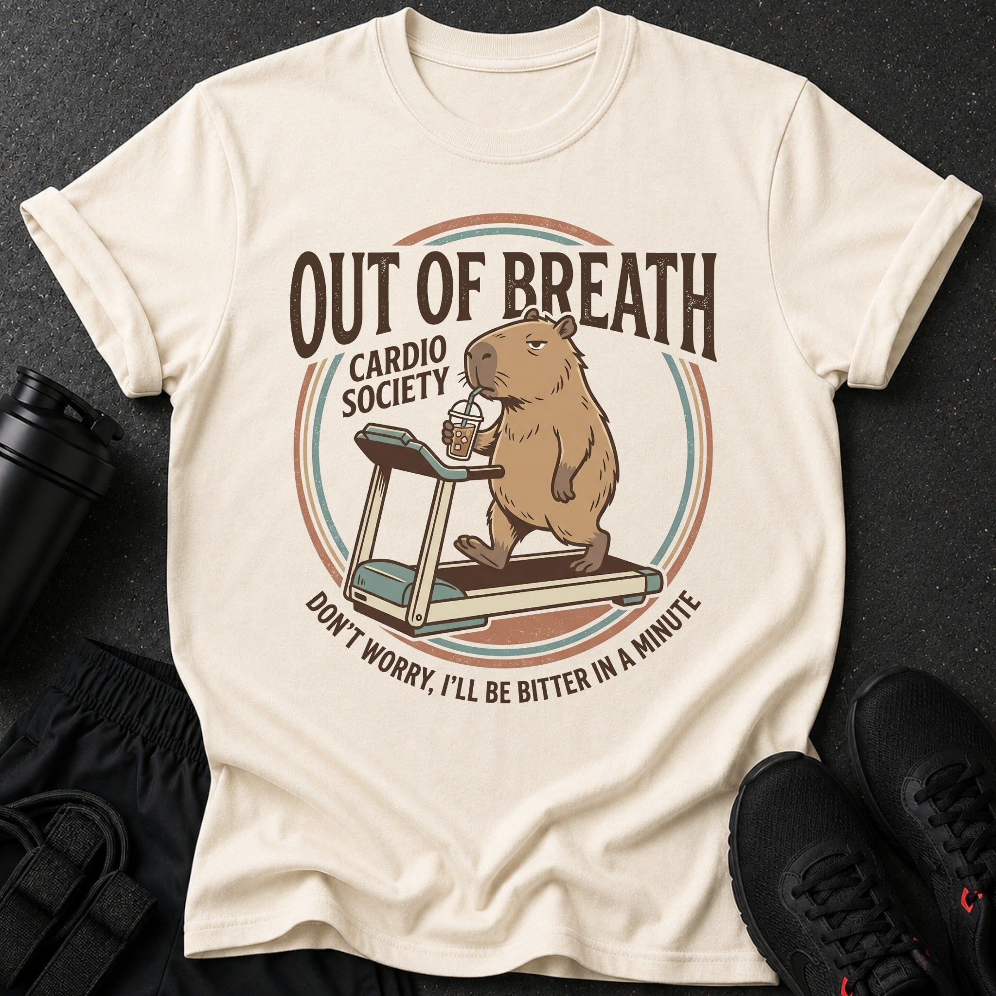 T-shirt with capybara on treadmill drinking from cup, "Out of Breath Cardio Society" text.
