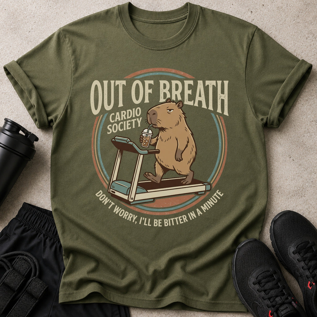 Olive green t-shirt with a capybara on a treadmill drinking from a cup.
