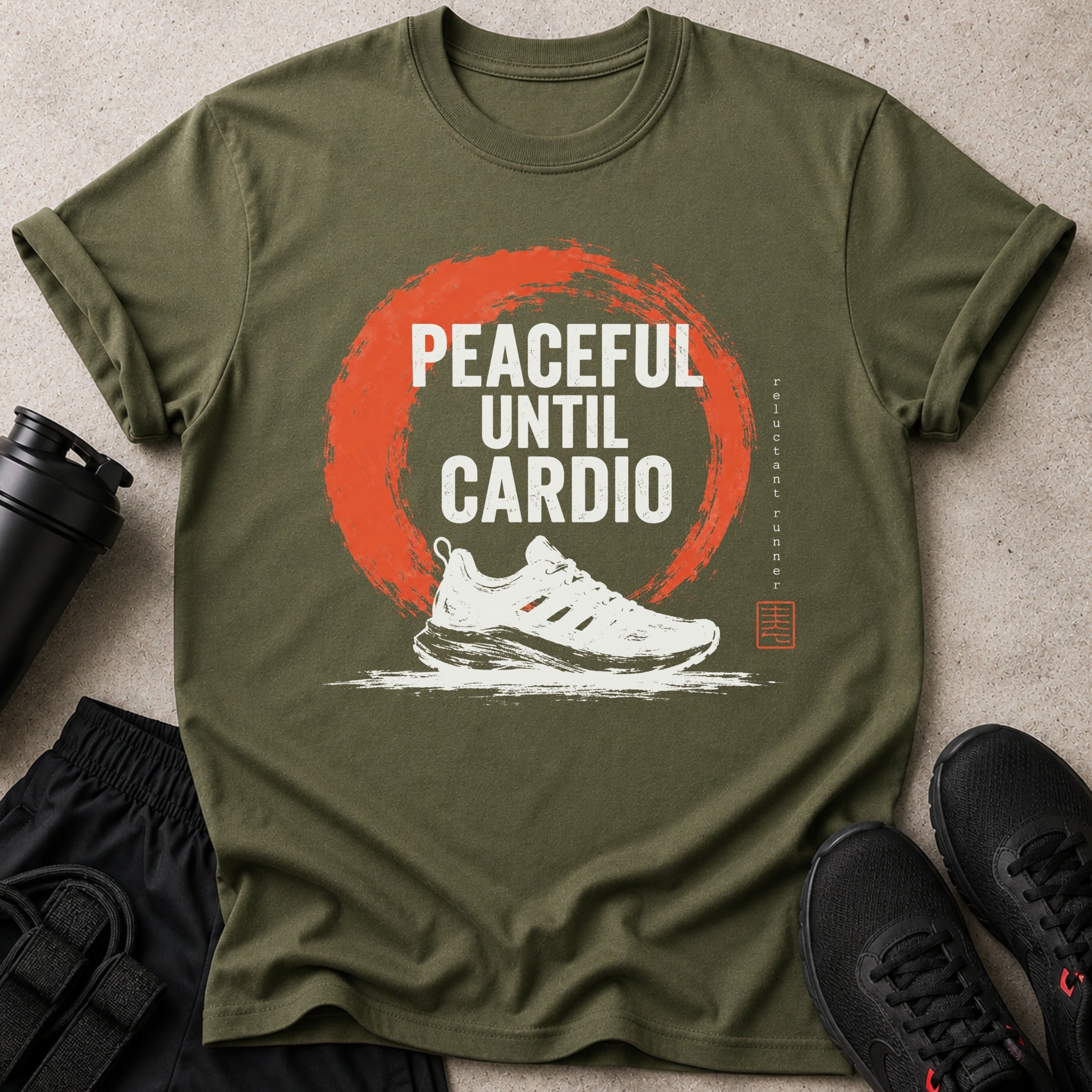 Olive t-shirt with "Peaceful Until Cardio" text, a running shoe, and a distressed orange circle.