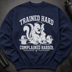 Navy sweatshirt with a skunk lifting weights and text: "TRAINED HARD COMPLAINED HARDER."