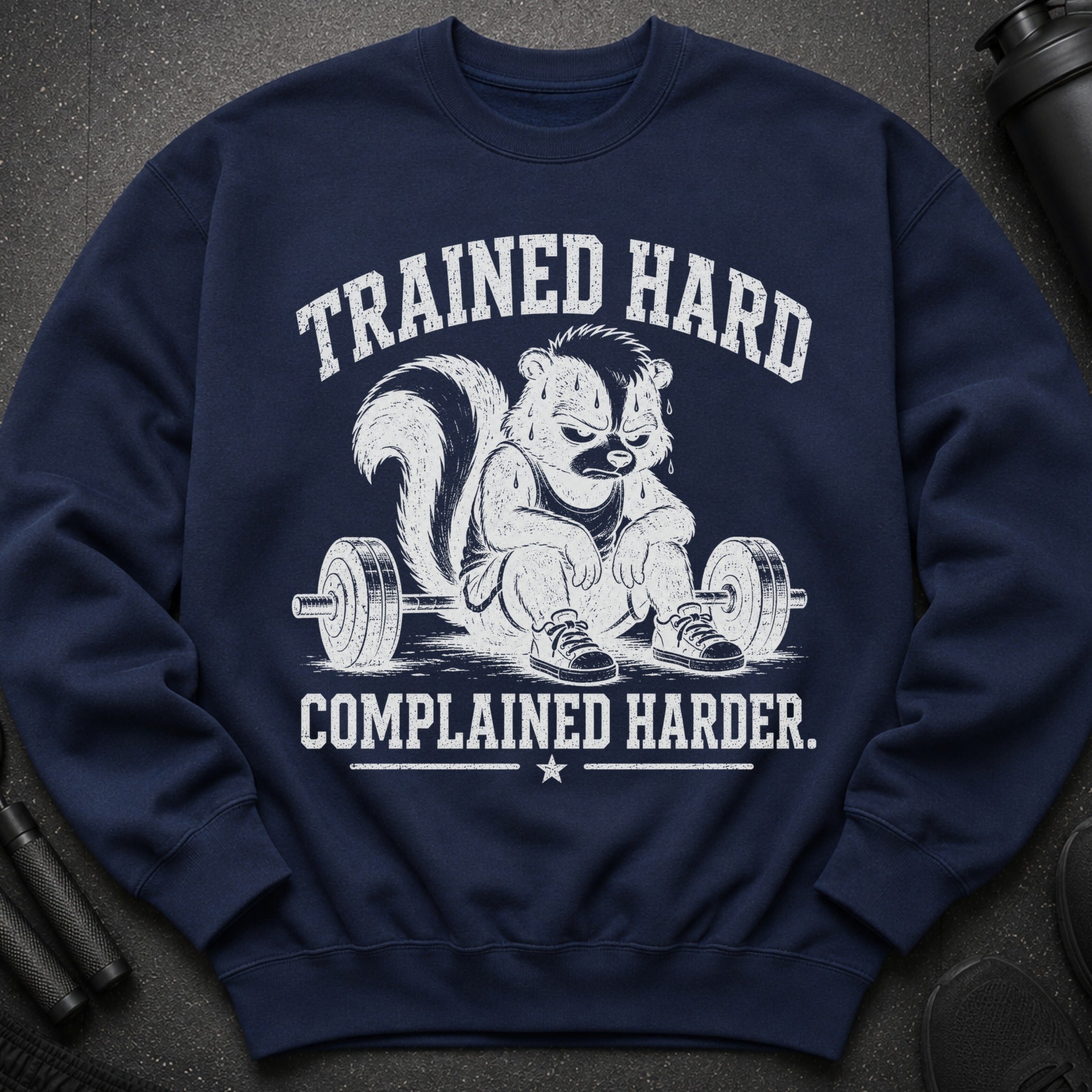 Navy sweatshirt with a skunk lifting weights and text: "TRAINED HARD COMPLAINED HARDER."