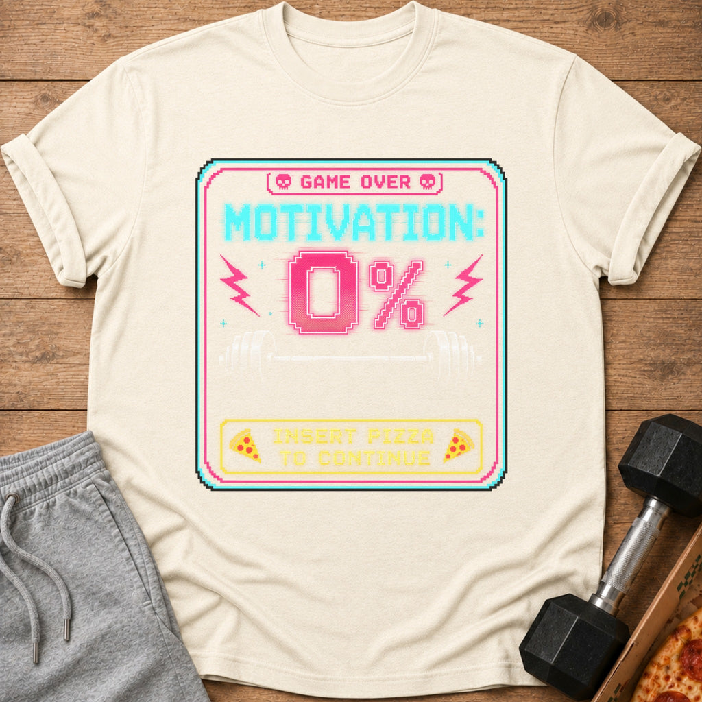 "Game Over Motivation: 0%" with barbell and pizza graphic on a cream t-shirt.