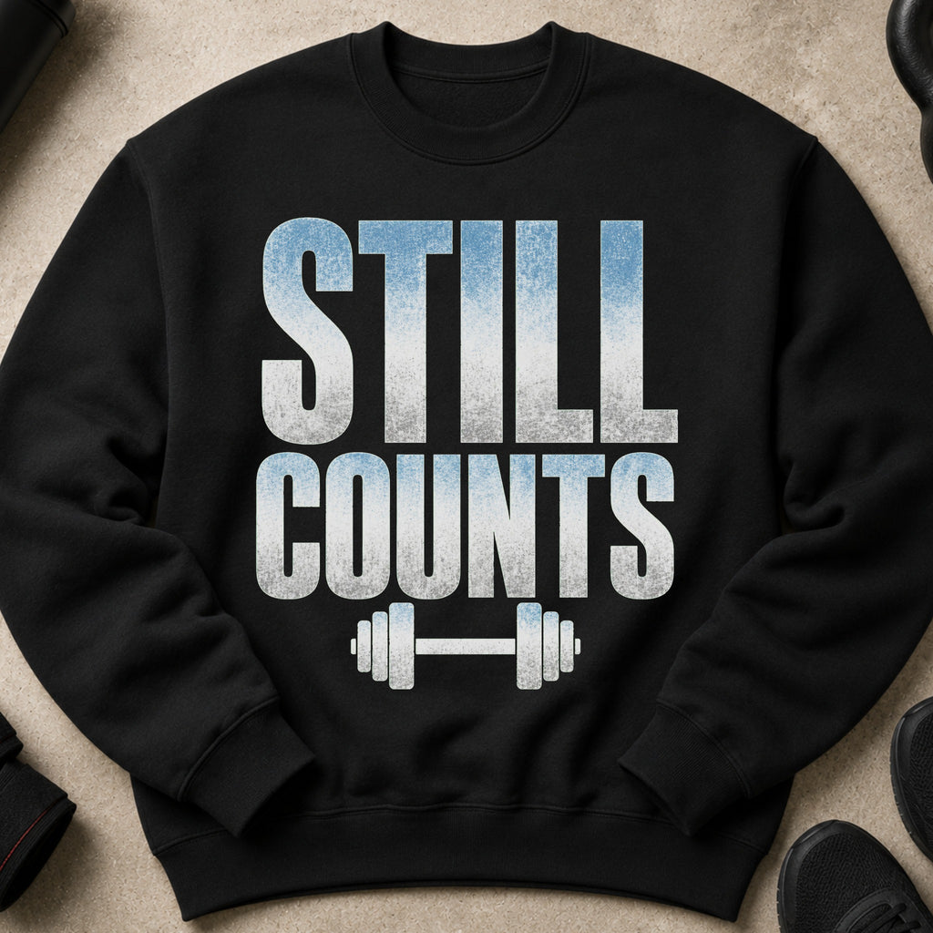 Black sweatshirt with distressed text "STILL COUNTS" and barbell graphic.