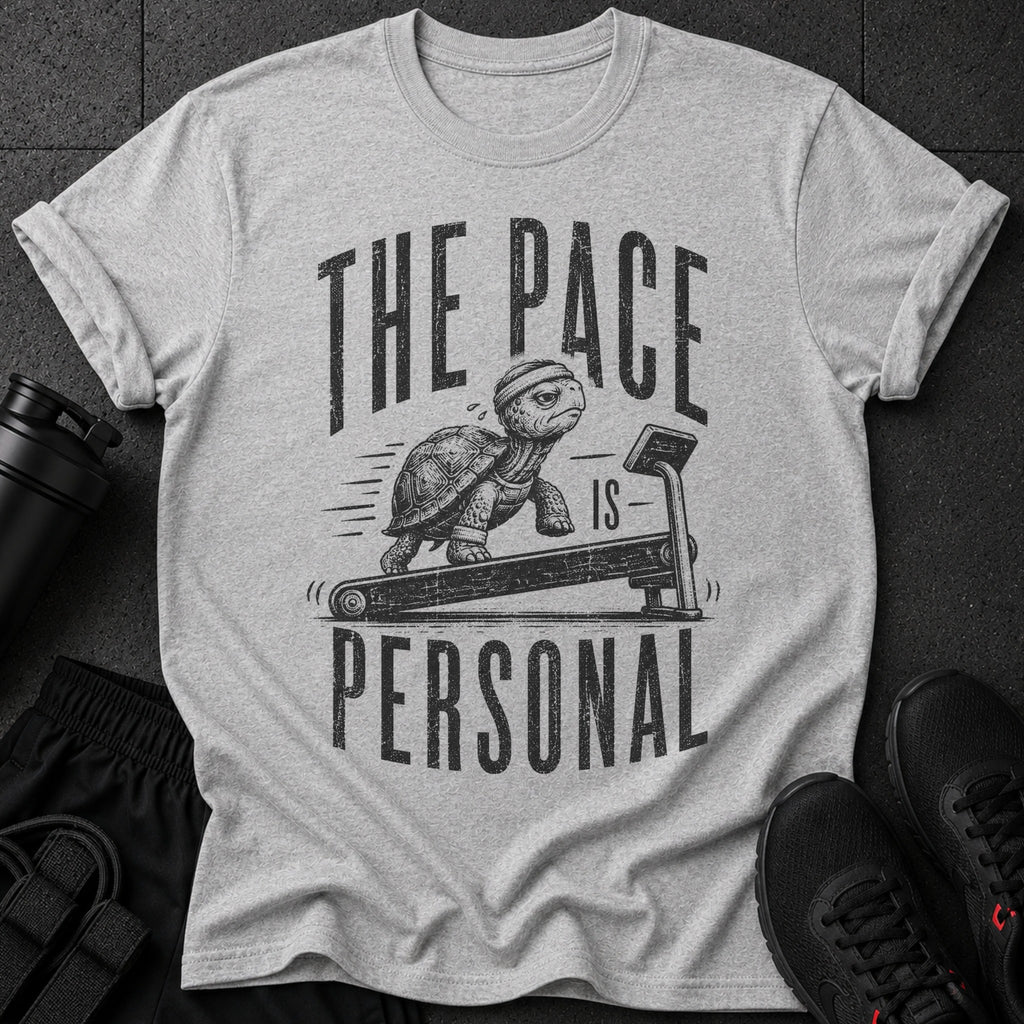 Grey t-shirt with tortoise on treadmill graphic and text "THE PACE IS PERSONAL".