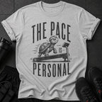 Grey t-shirt with tortoise on treadmill graphic and text "THE PACE IS PERSONAL".