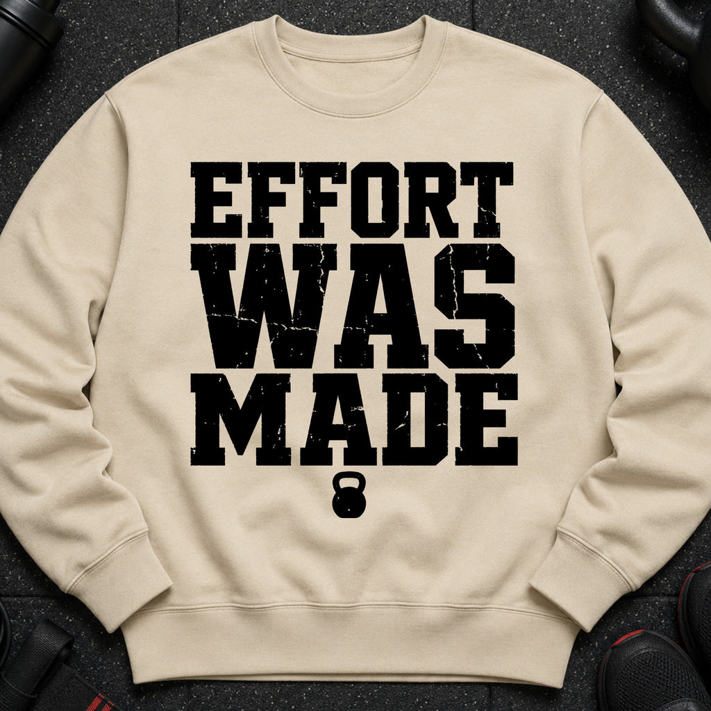 Tan sweatshirt with black text "EFFORT WAS MADE" and a kettlebell logo.