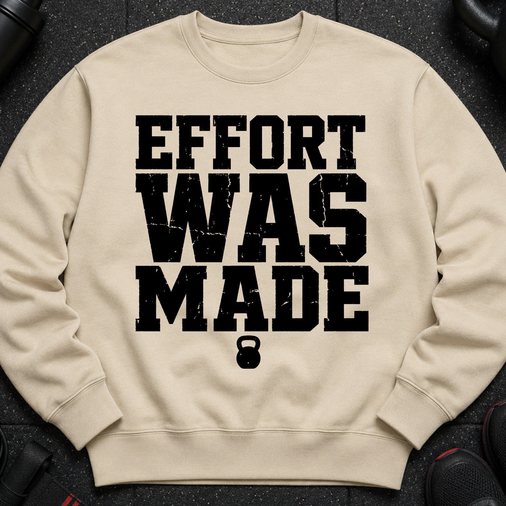 Tan sweatshirt with black text "EFFORT WAS MADE" and a kettlebell logo.