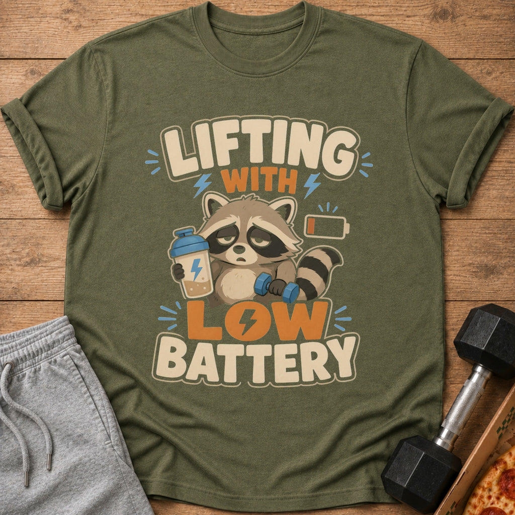 T-shirt with raccoon holding dumbbell and shaker, text "Lifting with low battery".