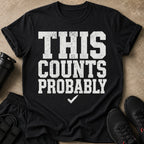 Black t-shirt with white distressed text "THIS COUNTS PROBABLY" and a checkmark.