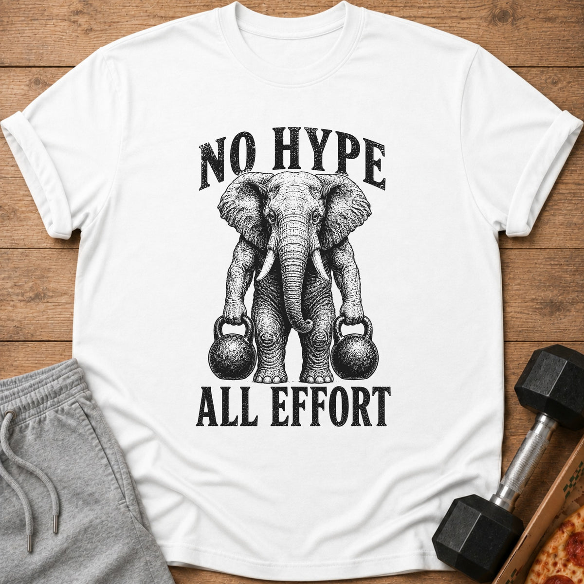 White t-shirt with illustration of elephant holding kettlebells and text "NO HYPE ALL EFFORT".