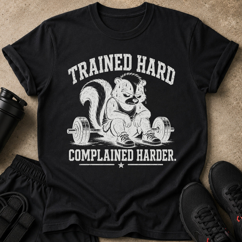 Black t-shirt with distressed graphic of a skunk lifting weights and text "TRAINED HARD COMPLAINED HARDER".