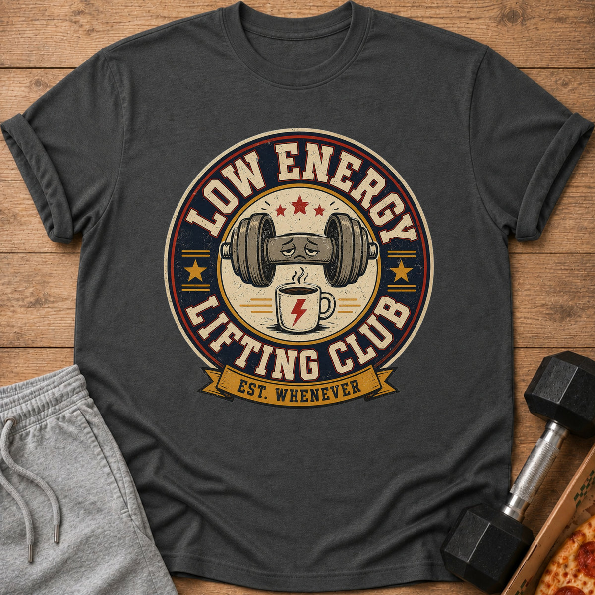 Dumbbell with sad face above coffee cup, text "Low Energy Lifting Club Est. Whenever".