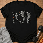 Black t-shirt with three dancing skeletons and falling autumn leaves graphic.