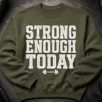 Olive green sweatshirt with white text "STRONG ENOUGH TODAY" and a barbell graphic.