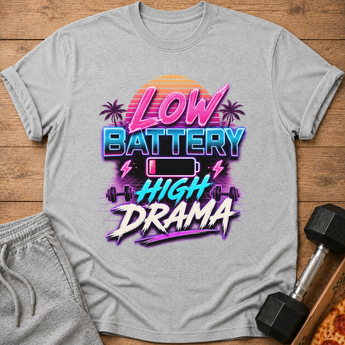 Grey t-shirt with "LOW BATTERY HIGH DRAMA" text, battery icon, and dumbbells.
