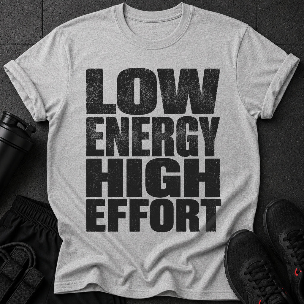 Gray t-shirt with "LOW ENERGY HIGH EFFORT" text, black athletic shorts, and shoes.