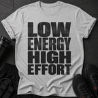 Gray t-shirt with "LOW ENERGY HIGH EFFORT" text, black athletic shorts, and shoes.