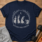 Navy t-shirt with "Witches Who Stretch" text and illustration of witches stretching.