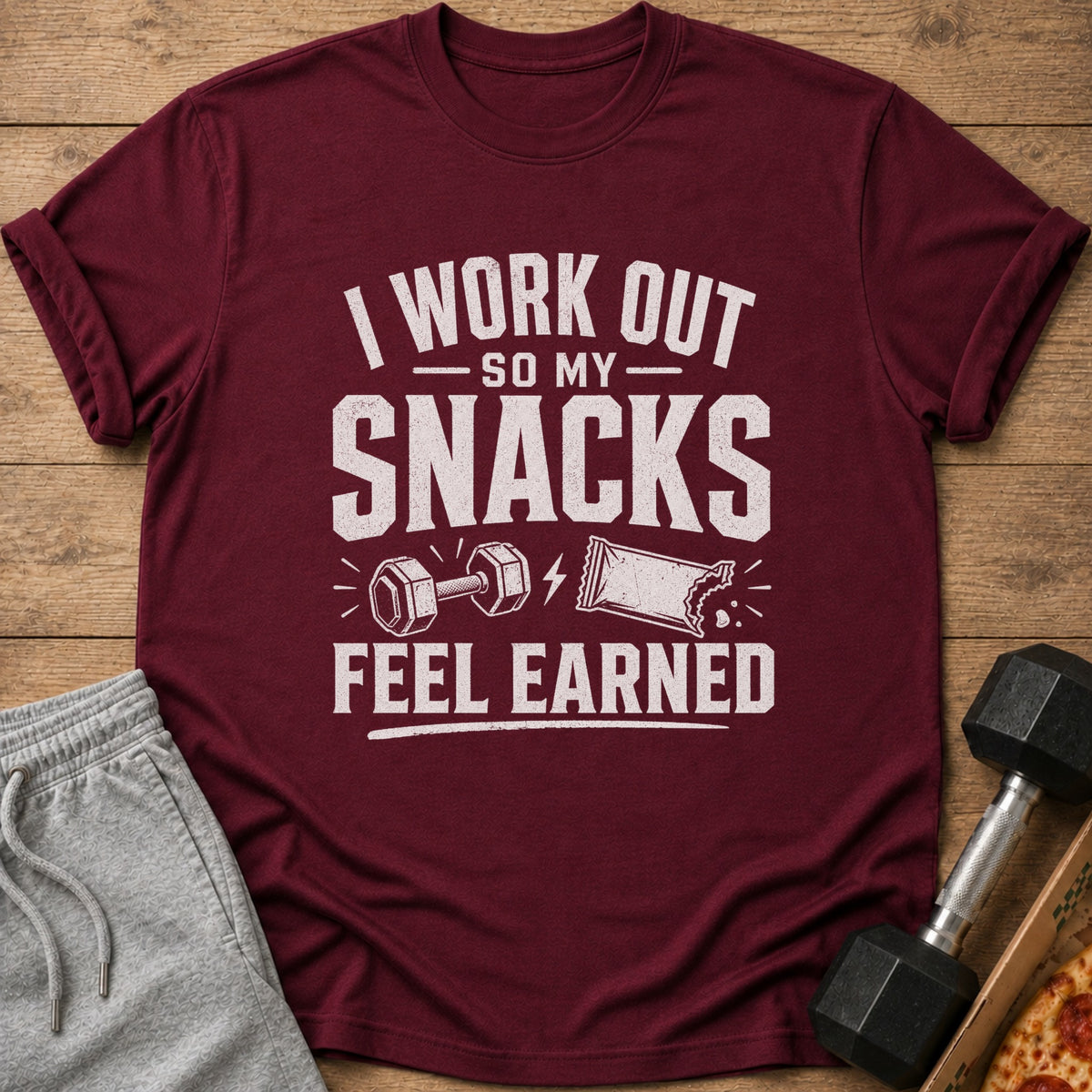 Maroon t-shirt with "I WORK OUT SO MY SNACKS FEEL EARNED" text and graphics.
