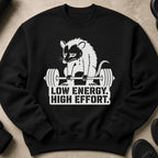 Black sweatshirt with a possum lifting weights and text "LOW ENERGY. HIGH EFFORT."