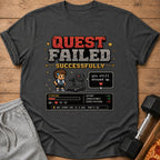 Dark gray t-shirt with "Quest Failed Successfully" pixel art graphic.