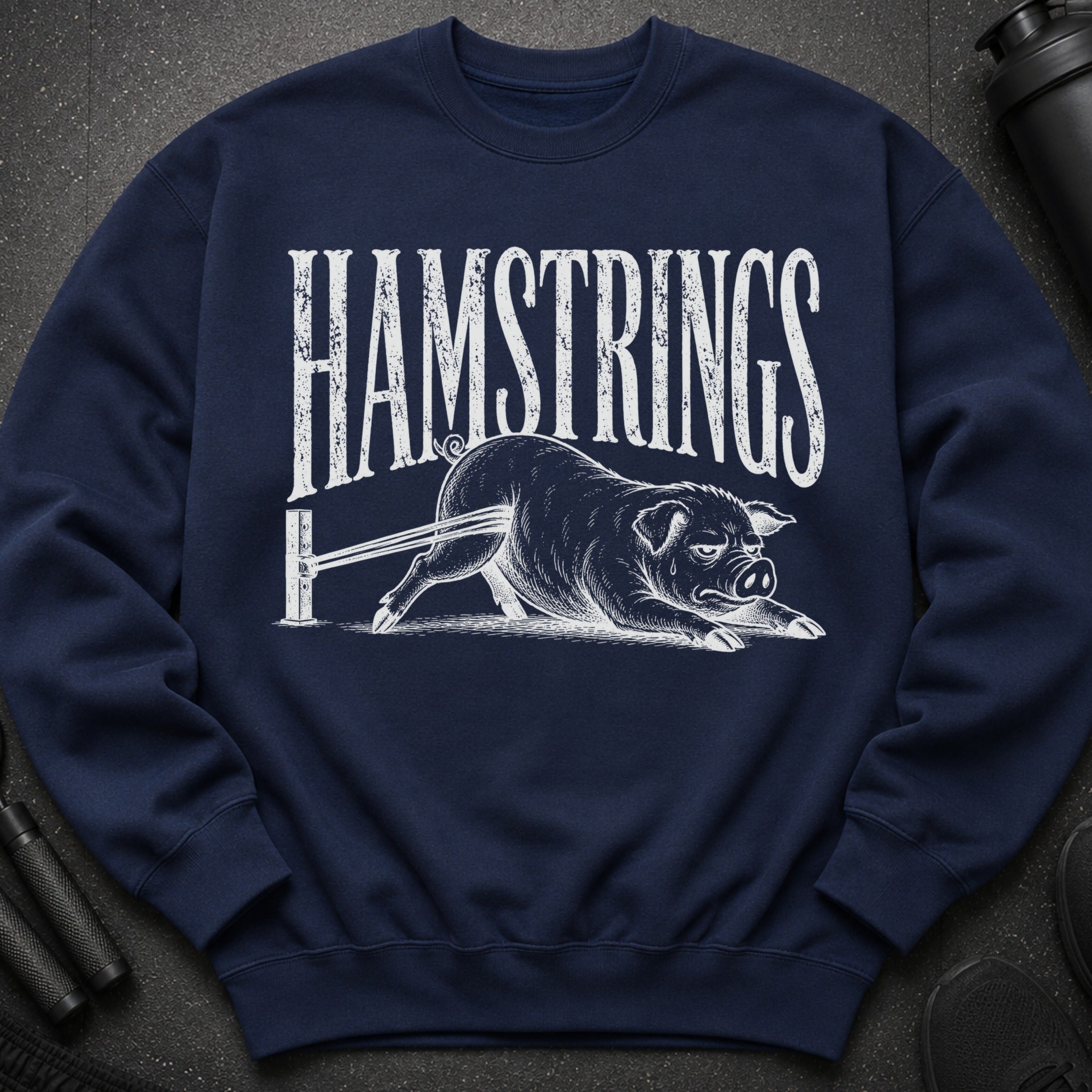 Navy sweatshirt with "HAMSTRINGS" text and a pig being stretched by resistance bands.
