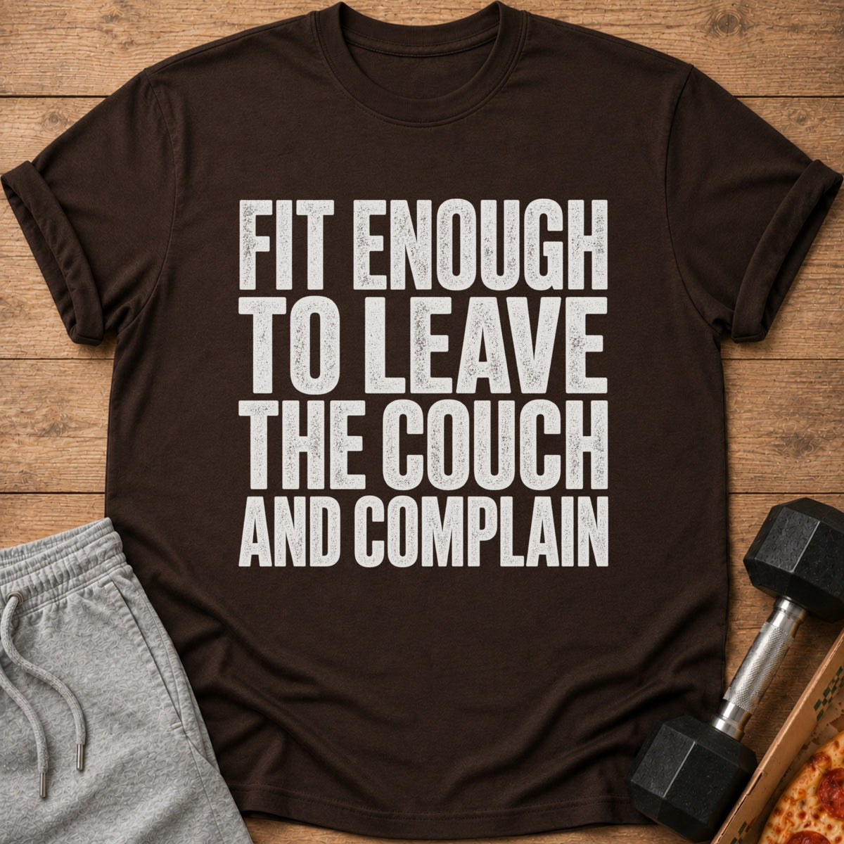 Brown t-shirt with white text: "Fit Enough To Leave The Couch And Complain".