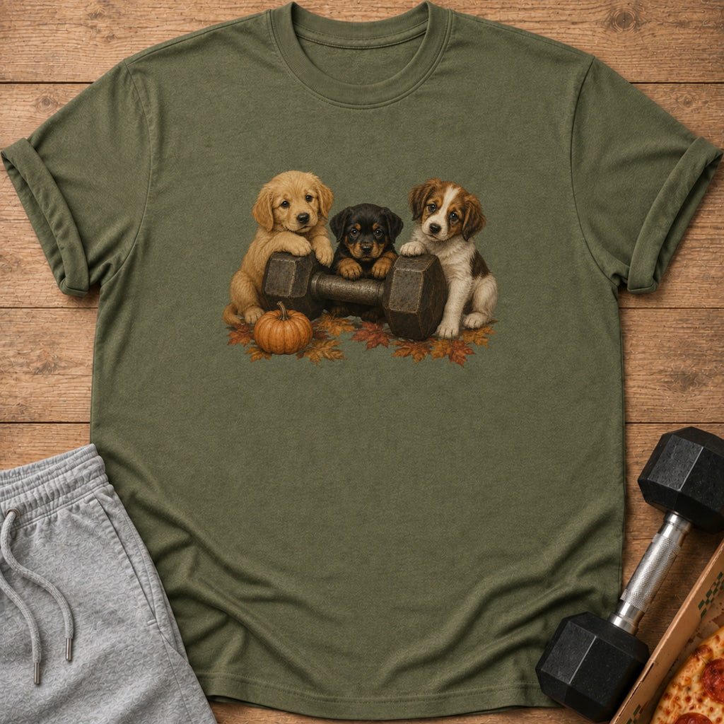 Three puppies sit on a dumbbell with autumn leaves and a pumpkin.