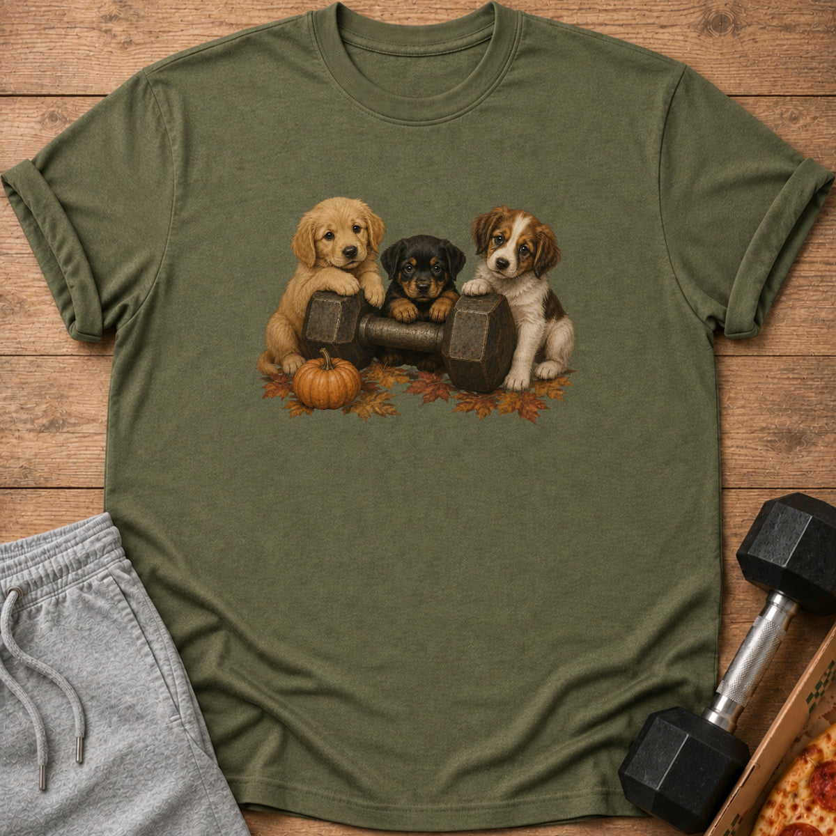 Three puppies sit on a dumbbell with autumn leaves and a pumpkin.