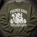 Olive green sweatshirt with distressed graphic of skunk sitting on barbell, text: "TRAINED HARD COMPLAINED HARDER".