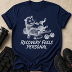 Navy t-shirt with opossum graphics and "Recovery Feels Personal" text.