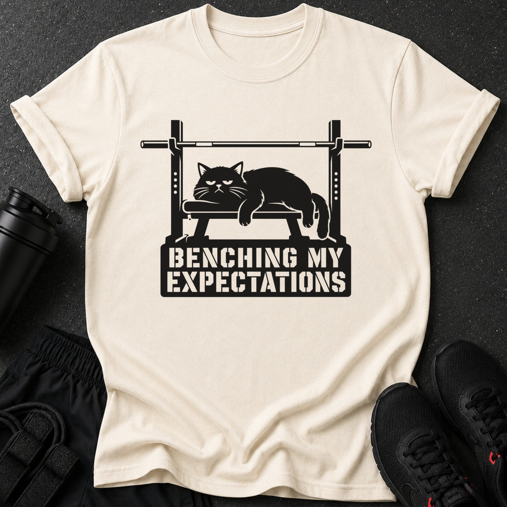 T-shirt with black cat on weight bench graphic and text "BENCHING MY EXPECTATIONS".