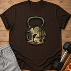 Brown t-shirt with kettlebell design featuring a gym interior and silhouetted person.