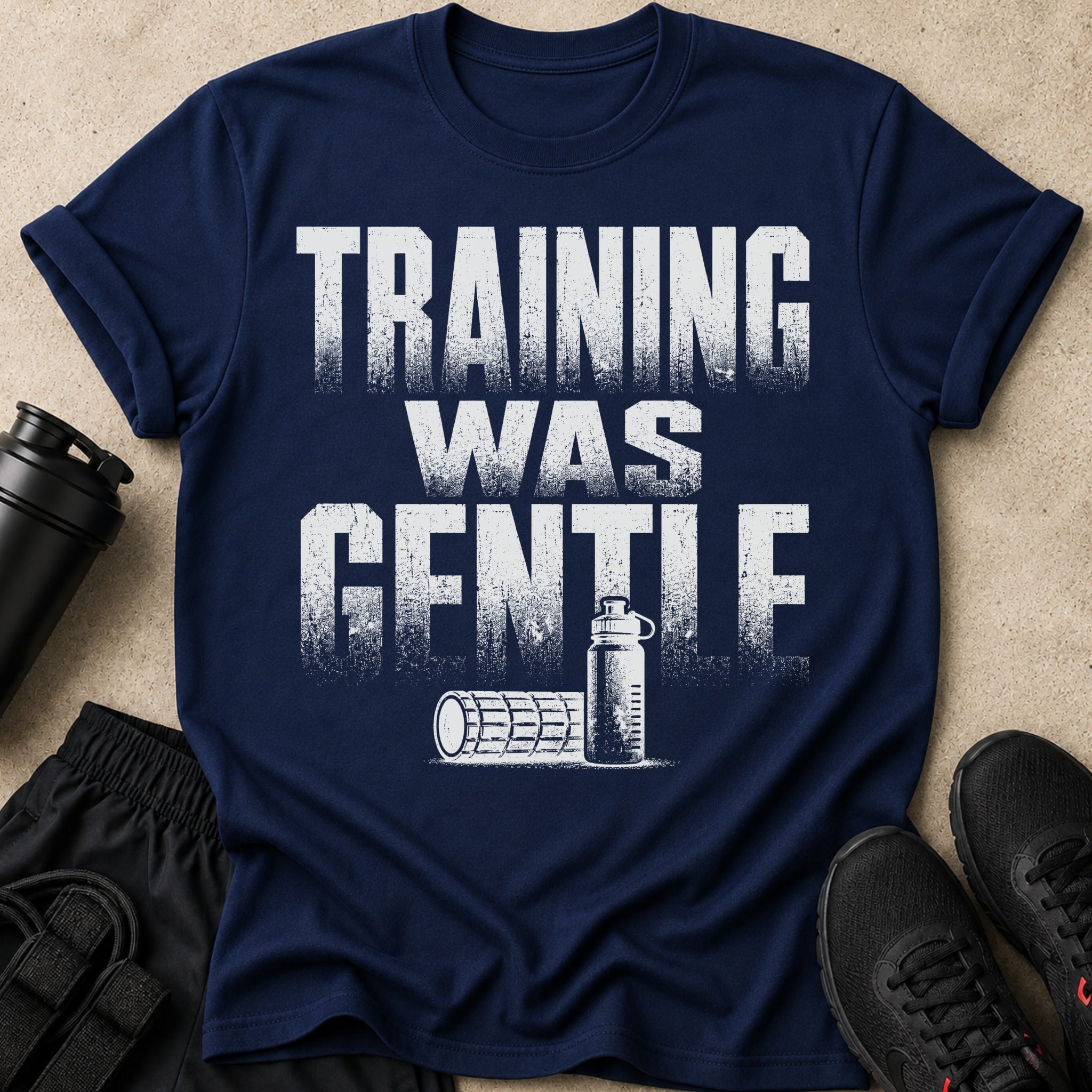 Navy t-shirt with distressed white text "TRAINING WAS GENTLE" and gym accessories.