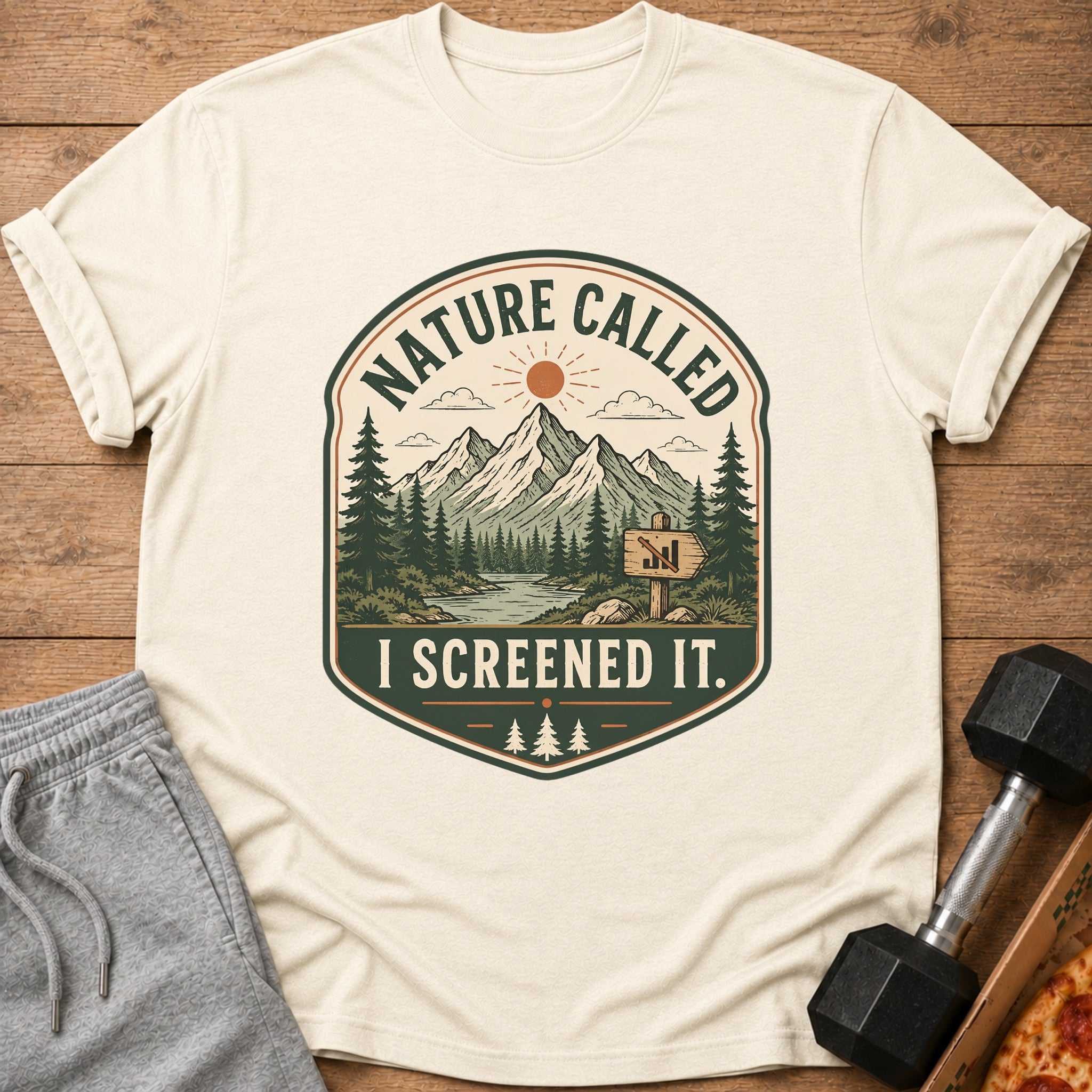 Cream t-shirt with "Nature Called I Screened It." mountain graphic.