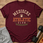 Maroon t-shirt with "Mediocre Athletic Club" and "Proudly Below Average" text.