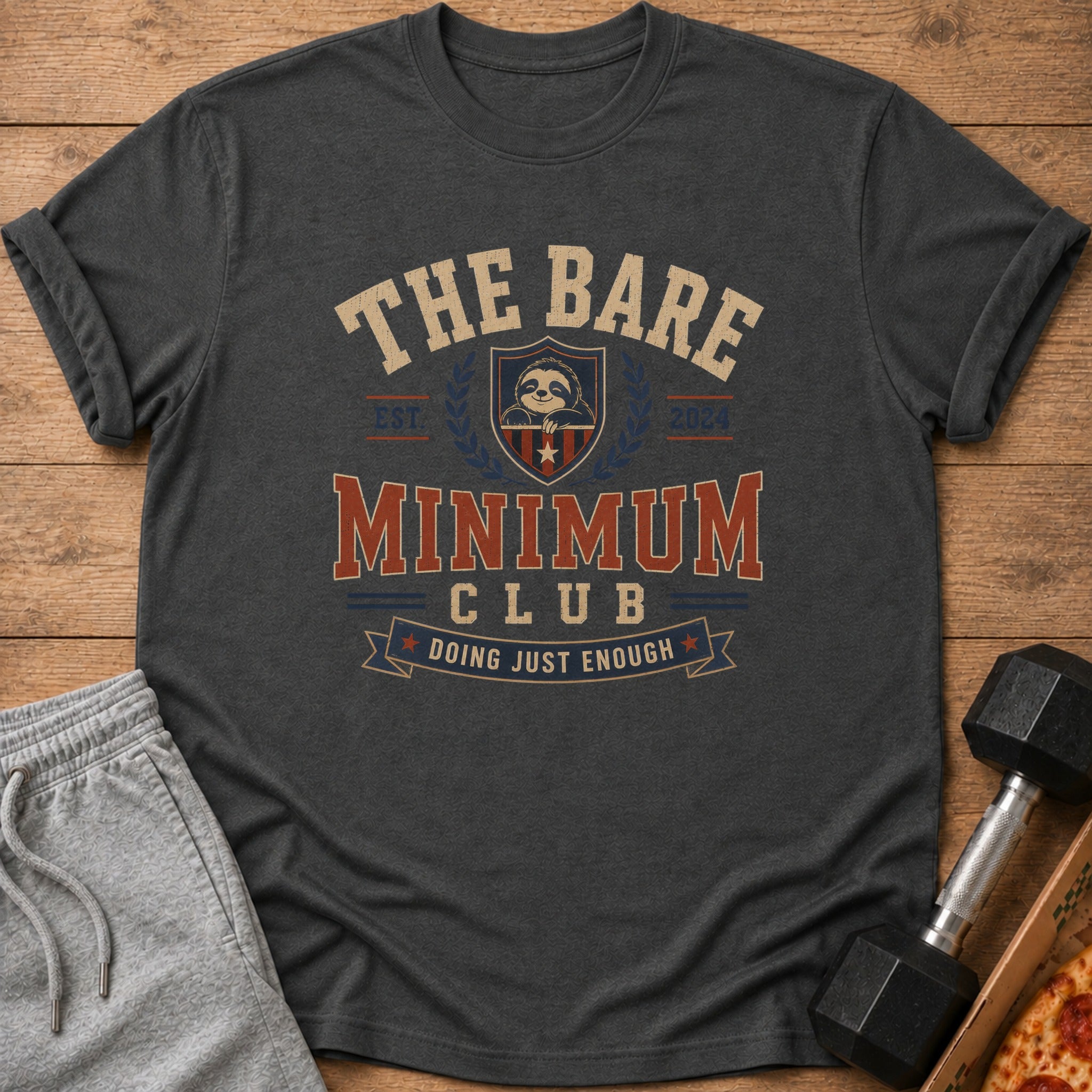 Dark grey t-shirt with text "The Bare Minimum Club Doing Just Enough" and a sloth.