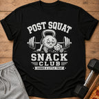 Black t-shirt with "POST SQUAT SNACK CLUB" text and a tired kettlebell holding a cookie.