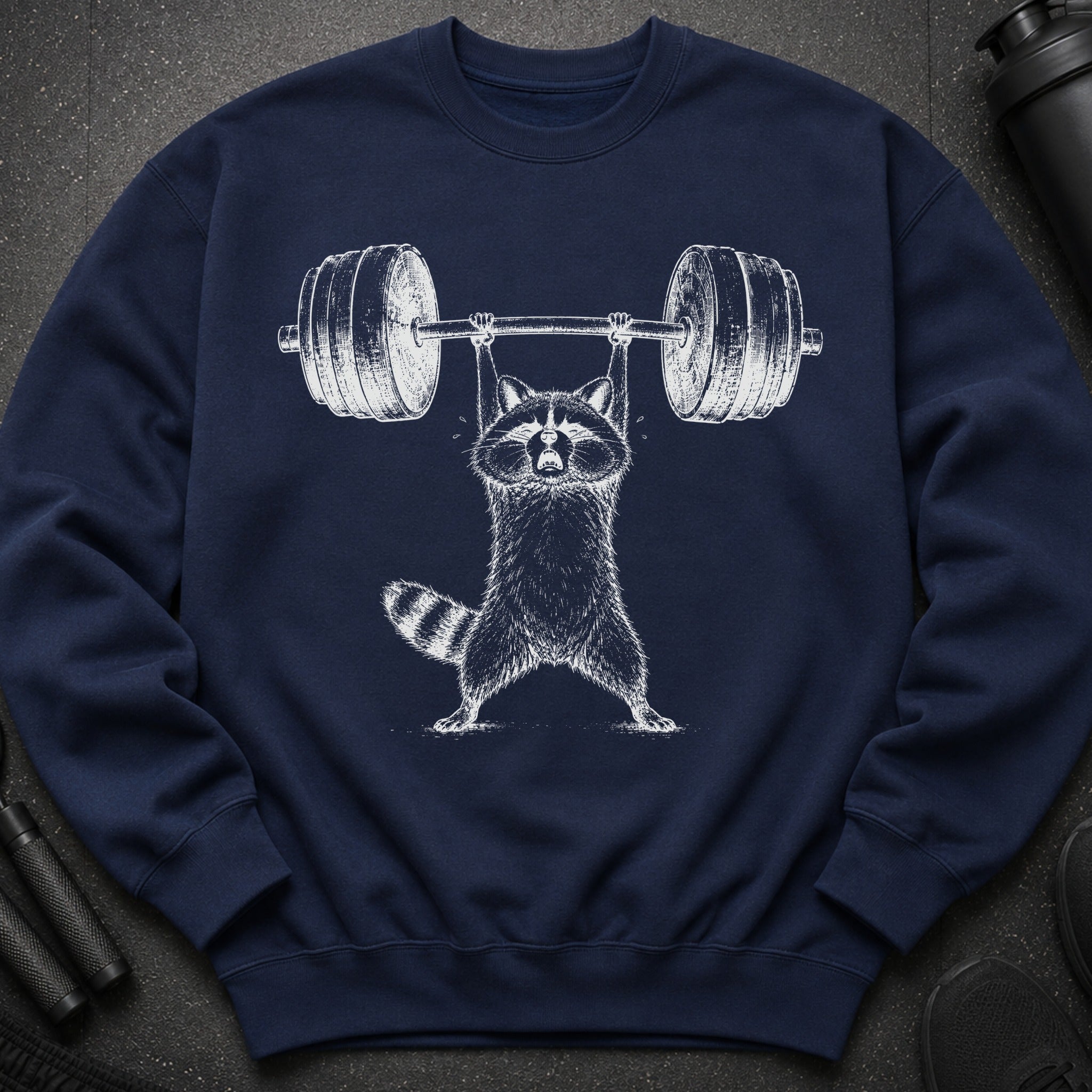 Navy sweatshirt with white graphic of a raccoon lifting a barbell.