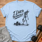 Light blue t-shirt with black graphic of a skeleton walking and dumbbells, text "I Lived, Technically".