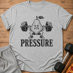 T-shirt with a pear lifting weights and the word "PRESSURE".