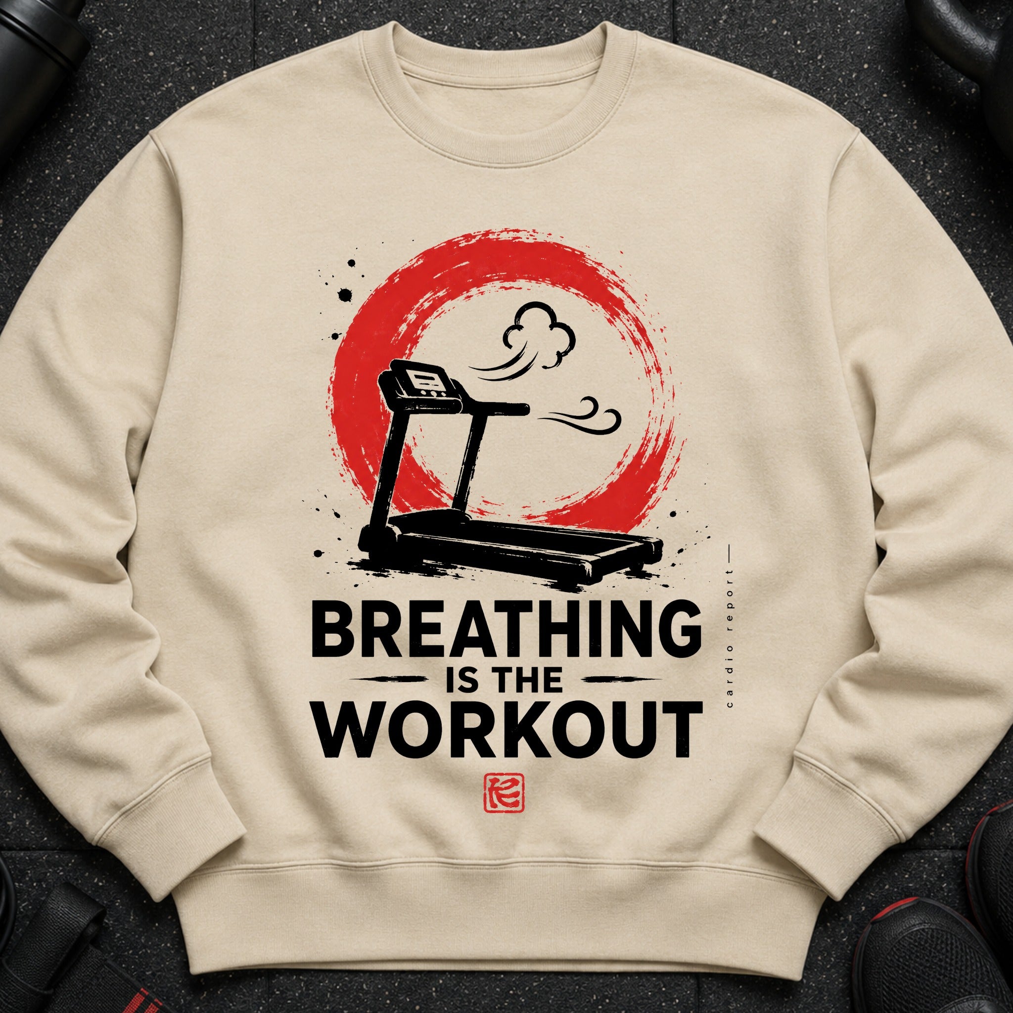 Cream sweatshirt with treadmill graphic and text "BREATHING IS THE WORKOUT".