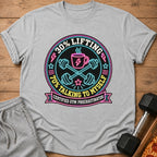 Gray t-shirt with a neon graphic stating "30% Lifting, 70% Talking to Myself, Certified Gym Procrastinator."