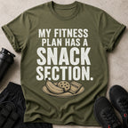 Olive green t-shirt with text "MY FITNESS PLAN HAS A SNACK SECTION" and graphics.