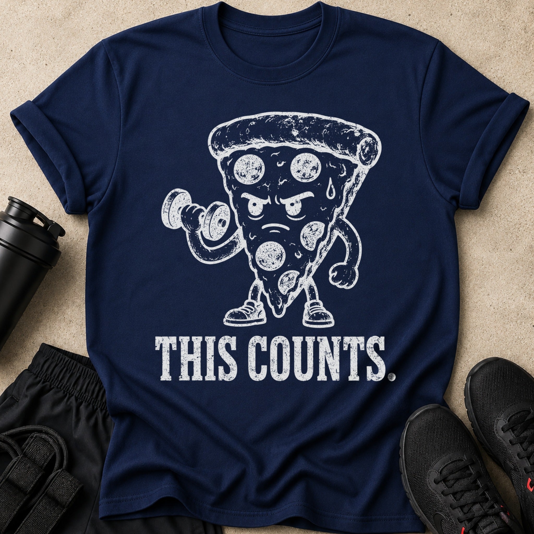 Navy t-shirt with distressed white graphic of a pizza slice lifting weights, text "THIS COUNTS.".