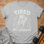 Grey t-shirt with a frog sitting by weights with text "TIRED BUT I SHOWED UP."